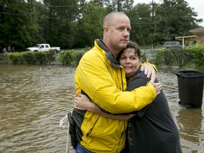 David White hugs his neighbor, Sherry Blincoe, after she was rescued by boat from her flooded home in Beaumont, Texas, on Wednesday Aug. 30, 2017. (Jay Janner/Austin American-Statesman via AP)