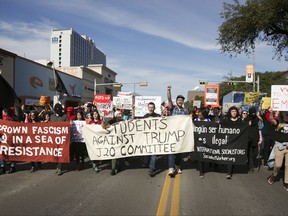 FILE - In this Friday, Jan. 20, 2017. file photo, anti-Donald Trump protesters block traffic as they march in the middle of Guadalupe Street next to the University of Texas at Austin on Inauguration Day. In 2017, Republican legislators in at least six states, including Texas, have introduced bills that would shield drivers from civil liability if they unintentionally injure or kill protesters obstructing traffic. (Jay Janner/Austin American-Statesman via AP)