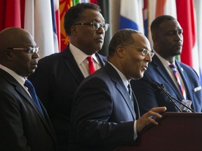 CORRECTS TO SAY THE COUNCIL MEMBER WERE CALLING FOR CONFEDERATE MONUMENTS TO BE REMOVED - African American Dallas City Council members, from left, Tennell Atkins, Mayor Pro Tem Dwaine Caraway, Kevin Felder and Casey Thomas speak at a news conference Friday, Aug. 18, 2017, at City Hall in Dallas calling for the city's Confederate statues to be removed as a way to heal the area's racist history. (Ashley Landis/The Dallas Morning News via AP)