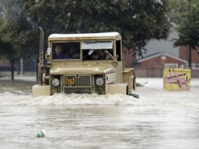 A truck pushes through floodwaters from Tropical Storm Harvey on Sunday, Aug. 27, 2017, in Houston, Texas.