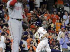 Houston Astros' Jake Marisnick, right, runs the bases after hitting a home run off Washington Nationals starting pitcher Edwin Jackson, left, during the fifth inning of a baseball game Wednesday, Aug. 23, 2017, in Houston. (AP Photo/David J. Phillip)
