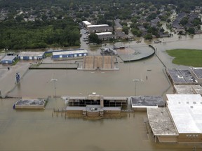 C.E. King High School's football field is covered by floodwaters from Tropical Storm Harvey Tuesday, Aug. 29, 2017, in Houston. (AP Photo/David J. Phillip)