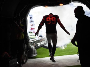 Houston Texans defensive end J.J. Watt (99) runs out of the tunnel as he is introduced before an NFL football preseason game against the New England Patriots Saturday, Aug. 19, 2017, in Houston. (AP Photo/Eric Christian Smith)