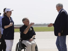 Texas Gov. Greg Abbott, center and his wife Cecilia, greet Vice President Mike Pence as he arrives to visit areas affected by Hurricane Harvey, Thursday, Aug. 31, 2017, in Corpus Christi, Texas. (AP Photo/Eric Gay)