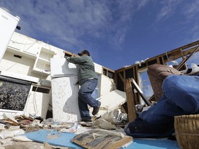 Felix Tijerina works to salvage items from his family's home that was destroyed in the wake of Hurricane Harvey, Tuesday, Aug. 29, 2017, in Rockport, Texas. (AP Photo/Eric Gay)