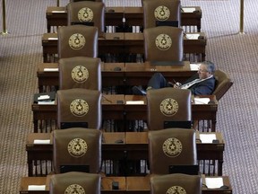 Texas Rep. Drew Springer, R-Gainsville, works at his desk as he waits for the House to convene, Tuesday, Aug. 15, 2017, in Austin. The special session will end Wednesday with the Texas 'bathroom bill' expected to fail. (AP Photo/Eric Gay)