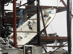 People check on a boat storage facility that was damaged by Hurricane Harvey, Saturday, Aug. 26, 2017, in Rockport, Texas. (AP Photo/Eric Gay)