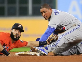 Houston Astros shortstop Marwin Gonzalez, left, looks to second base umpire Rob Drake for the call after Toronto Blue Jays' Ezequiel Carrera stole second during the fourth inning of a baseball game, Friday, Aug. 4, 2017, in Houston. (AP Photo/Eric Christian Smith)