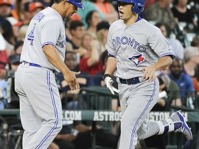 Toronto Blue Jays' Norichika Aoki, right, celebrates his two-run home run off Houston Astros starting pitcher Mike Fiers with third base coach Luis Rivera, during the seventh inning of a baseball game, Sunday, Aug. 6, 2017, in Houston. (AP Photo/Eric Christian Smith)