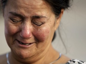 Frances Breaux cries as she talks about her fears for two close friends who live near the Arkema Inc. chemical plant Thursday, Aug. 31, 2017, in Crosby, Texas. Breaux said her close friends, an elderly couple that live close to the plant, have not been heard from Thursday. The Houston-area chemical plant that lost power after Harvey engulfed the area in extensive floods was rocked by multiple explosions early Thursday, the plant's operator said. (AP Photo/Gregory Bull)