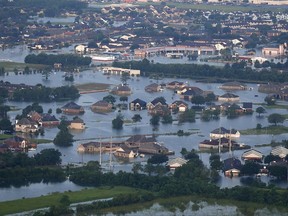 Floodwaters from Tropical Storm Harvey surround homes and businesses in Port Arthur, Texas, Thursday, Aug. 31, 2017. (AP Photo/Gerald Herbert)