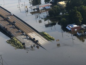 People launch boats from an overpass into floodwaters in the aftermath of Tropical Storm Harvey in Kountze, Texas, Thursday, Aug. 31, 2017. (AP Photo/Gerald Herbert)