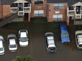 In this aerial photo, floodwaters from Tropical Storm Harvey surround an apartment complex on Tuesday, Aug. 29, 2017, in Houston.  Houston officials plan to open two or three more mega-shelters to accommodate people who continue to arrive at the overflowing George R. Brown Convention Center seeking refuge from Harvey's record-breaking flooding.  (Brett Coomer/Houston Chronicle via AP)