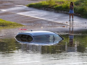 A flooded vehicle is submerged along Studemont Street near Interstate 10, Tuesday, Aug. 8, 2017, in Houston. Torrential rains have brought more flooding to the Houston area as emergency officials urge motorists to stay home until the water recedes. (Godofredo A. Vasquez/Houston Chronicle via AP)