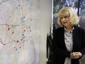 In this photo made Wednesday, May 24, 2017, Becky Biser, director of leadership at the Tarrant Baptist Association, describes a map indicating churches that are located in areas of Fort Worth where research is predicting that there's a high risk of child abuse and neglect occurring, in Fort Worth, Texas. She said her organization, is using the research to try to focus outreach efforts. (AP Photo/LM Otero)