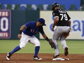 Chicago White Sox's Jose Abreu (79) is tagged out after sliding into second base by Texas Rangers shortstop Elvis Andrus in the second inning of a baseball game Friday, Aug. 18, 2017, in Arlington, Texas. (AP Photo/Mike Stone)