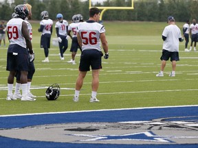 Houston Texans' Whitney Mercilus (59) and Brian Cushing (56) stand on the field as they wait to participate in drills during a morning practice at the Dallas Cowboys training facility, Monday, Aug. 28, 2017, in Frisco, Texas. The Texans are working out in the practice facility of the Cowboys because of floods pounding Houston. An exhibition game in the Texans' stadium Thursday might be moved to the home of the Cowboys. (AP Photo/Tony Gutierrez)