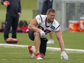 Houston Texans defensive end J.J. Watt stretches at the start of a morning practice at the Dallas Cowboys training facility, Monday, Aug. 28, 2017, in Frisco, Texas. The Texans are working out in the practice facility of the Dallas Cowboys because of floods pounding Houston. An exhibition game in the Texans' stadium Thursday might be moved to the home of the Cowboys. (AP Photo/Tony Gutierrez)