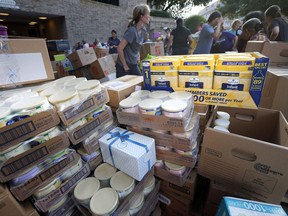Boxes of infant formula are stacked by volunteers after they were donated for hurricane Harvey victims at a North Dallas donation point, Tuesday, Aug. 29, 2017. (AP Photo/Tony Gutierrez)
