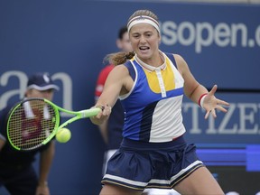 Jelena Ostapenko, of Latvia, returns a shot from Lara Arruabarrena, of Spain, during the first round of the U.S. Open tennis tournament, Tuesday, Aug. 29, 2017, in New York. (AP Photo/Seth Wenig)