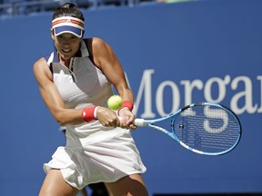 Garbine Muguruza, of Spain, returns a shot from Varvara Lepchenko, of the United States, during the first round of the U.S. Open tennis tournament, Monday, Aug. 28, 2017, in New York. (AP Photo/Seth Wenig)