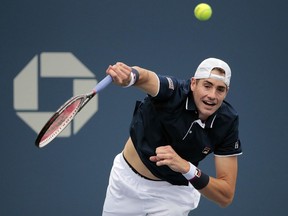 John Isner, of the United States, serves to Pierre-Hugues Herbert, of France, during the first round of the U.S. Open tennis tournament, Monday, Aug. 28, 2017, in New York. (AP Photo/Andres Kudacki)