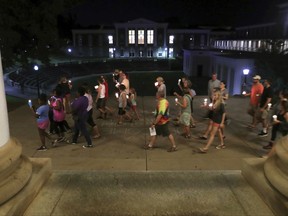 People participate in a candlelight vigil at the University of Virginia Wednesday night, Aug. 16, 2017, in Charlottesville, Va. Hundreds of people gathered for the vigil against hate and violence days after Charlottesville erupted in chaos during a white nationalist rally. (Andrew Shurtleff /The Daily Progress via AP)