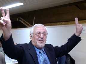 FILE - In this May 14, 2005 file photo, Ebrahim Yazdi, once Iran's Foreign Minister, flashes the victory sign, as he arrives at the Interior Ministry, to register as a presidential candidate, in Tehran, Iran. Iran's official IRNA news agency says one of the country's most influential dissident politicians who once served as foreign minister, Ebrahim Yazdi, has died. He was 85. The report of Monday, Aug. 28, 2017, says Yazdi died in Izmir, Turkey, due to complications from cancer.  (AP Photo/Vahid Salemi, File)
