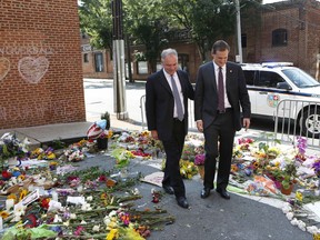 Sen. Tim Kaine, left, and Charlottesville mayor Michael Signer visit a makeshift memorial Wednesday, Aug. 16, 2017, where Heather Heyer was killed when a car rammed into a crowd of people protesting a white nationalist rally Charlottesville, Va. (AP Photo/Julia Rendleman)
