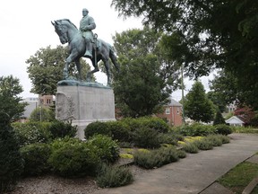 The statue of Confederate General Robert E. Lee still stands in Lee park in Charlottesville, Va., Monday, Aug. 14, 2017. The removal of the statue is in litigation and is at the center of the racial tensions and demonstrations in the town. (AP Photo/Steve Helber)