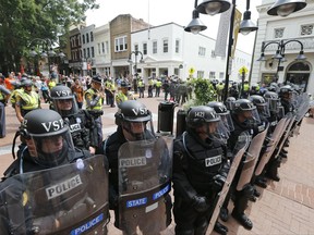 Virginia State Police cordon off an area around the site where a car ran into a group of protesters after a white nationalist rally in Charlottesville, Va., Saturday, Aug. 12, 2017.