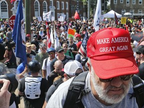 A white nationalist demonstrator walks into Lee Park in Charlottesville, Va., Saturday, Aug. 12, 2017.