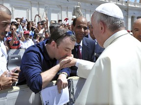 In this June 4, 2014 photo Irish psychotherapist Vincent Doyle kisses Pope Francis' hand during a general audience in St. Peter's Square, at the Vatican. With the support of the archbishop of Dublin, Doyle in 2014 launched an online resource for children of Roman Catholic Priests and was instrumental in the development of guidelines by the Irish bishops' conference to address the issue.  (Pool Photo via AP)