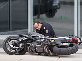 A police officer examines a motorcycle after a female stunt driver working on the movie "Deadpool 2" died after a crash on set, in Vancouver, B.C., on Monday August 14, 2017. Monday's deadly crash on the set of "Deadpool 2" is a rarity in an industry that takes extreme precautions to ensure safety but acknowledges there is always an element of risk involved, say stunt professionals. THE CANADIAN PRESS/Darryl Dyck