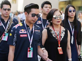Red bull heir Vorayuth "Boss" Yoovidhya walks with his mother, Daranee, at the Formula 1 Grand Prix in Abu Dhabi on Nov. 26, 2016.
