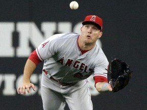 Los Angeles Angels center fielder Mike Trout dives toward a fly ball from Seattle Mariners' Ben Gamel before making the catch during the fourth inning of a baseball game Thursday, Aug. 10, 2017, in Seattle. (AP Photo/Elaine Thompson)
