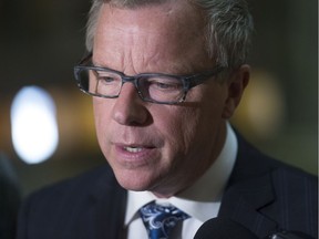 Brad Wall speaks to reporters at the Legislative Building.