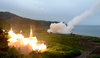 South Korea’s Hyunmoo II Missile system, left, and a U.S. Army Tactical Missile System, right, fire missiles during a joint military exercise at an undisclosed location in South Korea, July 29, 2017.