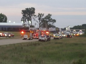 Emergency response vehicles gather at Great Lakes Dragaway on Sunday, Aug. 13, 2017, near Union Grove, Wis. Three men were shot and killed during an auto racing event at the facility, a Wisconsin sheriff said. Kenosha County Sheriff David Beth said authorities responded around 7 p.m. after receiving reports about shots being fired. The three men were shot by another man at point-blank range near a food vendor, Beth said at a news conference Sunday night. No suspects were arrested and no one else was injured. (Terry Flores/Kenosha News via AP)