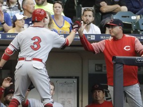 Cincinnati Reds manager Bryan Price congratulates Patrick Kivlehan (3) after his two-run home run during the fourth inning of a baseball game against the Milwaukee Brewers Saturday, Aug. 12, 2017, in Milwaukee. (AP Photo/Morry Gash)