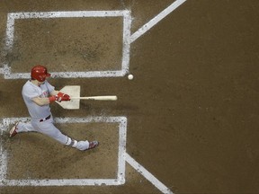 Cincinnati Reds' Scooter Gennett hits a two-run scoring single during the third inning of a baseball game against the Milwaukee Brewers Friday, Aug. 11, 2017, in Milwaukee. (AP Photo/Morry Gash)