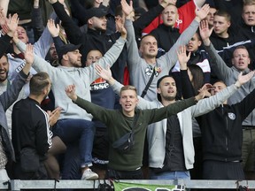Hannover soccer club fans react in the stands after the game against Burnley is abandoned during the pre-season friendly match at Turf Moor, Burnley, Saturday Aug. 5, 2017. Burnley's pre-season friendly with German side Hannover was abandoned due to crowd trouble. (Richard Sellers/PA via AP)