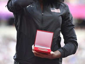 Francena McCorory of the United Sates wipes away a tear after she received her bronze medal during a ceremony at the World Athletics Championships in London Friday, Aug. 4, 2017. McCorory originally finished fourth in the women's 400m at the World Championships in Daegu in 2011but was promoted from fourth to bronze following the disqualification of the results of the original medallist after their sanction for anti-doping rule violations. (AP Photo/Martin Meissner)