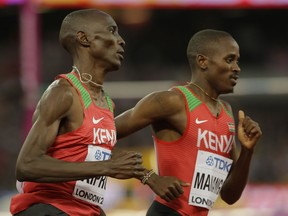 Kenya's Elijah Motonei Manangoi, right, and Kenya's Asbel Kiprop race in a Men's 1500m heat during the World Athletics Championships in London, Thursday, Aug. 10, 2017. (AP Photo/Alastair Grant)