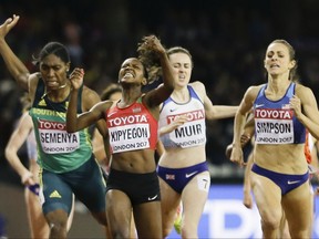 Kenya's Faith Chepngetich Kipyegon celebrates as she wins the gold medal in the final of the Woman's 1500m during the World Athletics Championships in London Monday, Aug. 7, 2017. Others from left are South Africa's Caster Semenya, Britain's Laura Muir and United States' Jennifer Simpson. (AP Photo/David J. Phillip)
