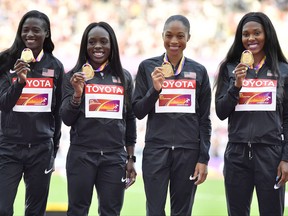 United States' Women's 4x100 meters relay team, from left,Teri Bowie, Aalyah Brown, Allyson Felix and Morolake Akinsosun pose on the podium with their gold medal at the World Athletics Championships in London Sunday, Aug. 13, 2017. (AP Photo/Martin Meissner)