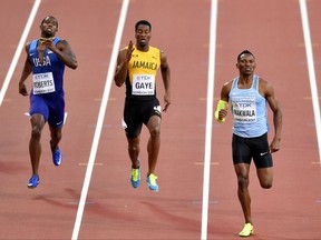 Botswana's Isaac Makwala, right, leads the field to the finish line in his heat of the Men's 400 meters during the World Athletics Championships in London Sunday, Aug. 6, 2017. (AP Photo/Martin Meissner)