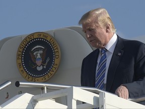 President Donald Trump walks down the steps of Air Force One at Tri-State Airport in Huntington, W.Va., Thursday, Aug. 3, 2017. Trump is in West Virginia for a campaign-style rally in Huntington, W.Va., where it is expected that West Virginia Gov. Jim Justice, a Democrat, will announce at the rally with Trump that he is changing parties. (AP Photo/Susan Walsh)