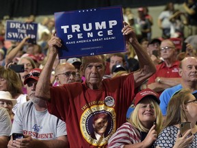People cheer as they wait for President Donald Trump to speak at a campaign-style rally at Big Sandy Superstore Arena in Huntington, W.Va., Thursday, Aug. 3, 2017. (AP Photo/Susan Walsh)