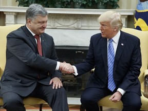 FILE - In this June 20, 2017, file photo, President Donald Trump shakes hands with Ukrainian President Petro Poroshenko during a meeting in the Oval Office of the White House in Washington. Seeking leverage with Russia, the Trump administration has reopened consideration of long-rejected plans to give Ukraine lethal weapons, even if that would plunge the United States deeper into the former Soviet republic's conflict. (AP Photo/Evan Vucci, File)